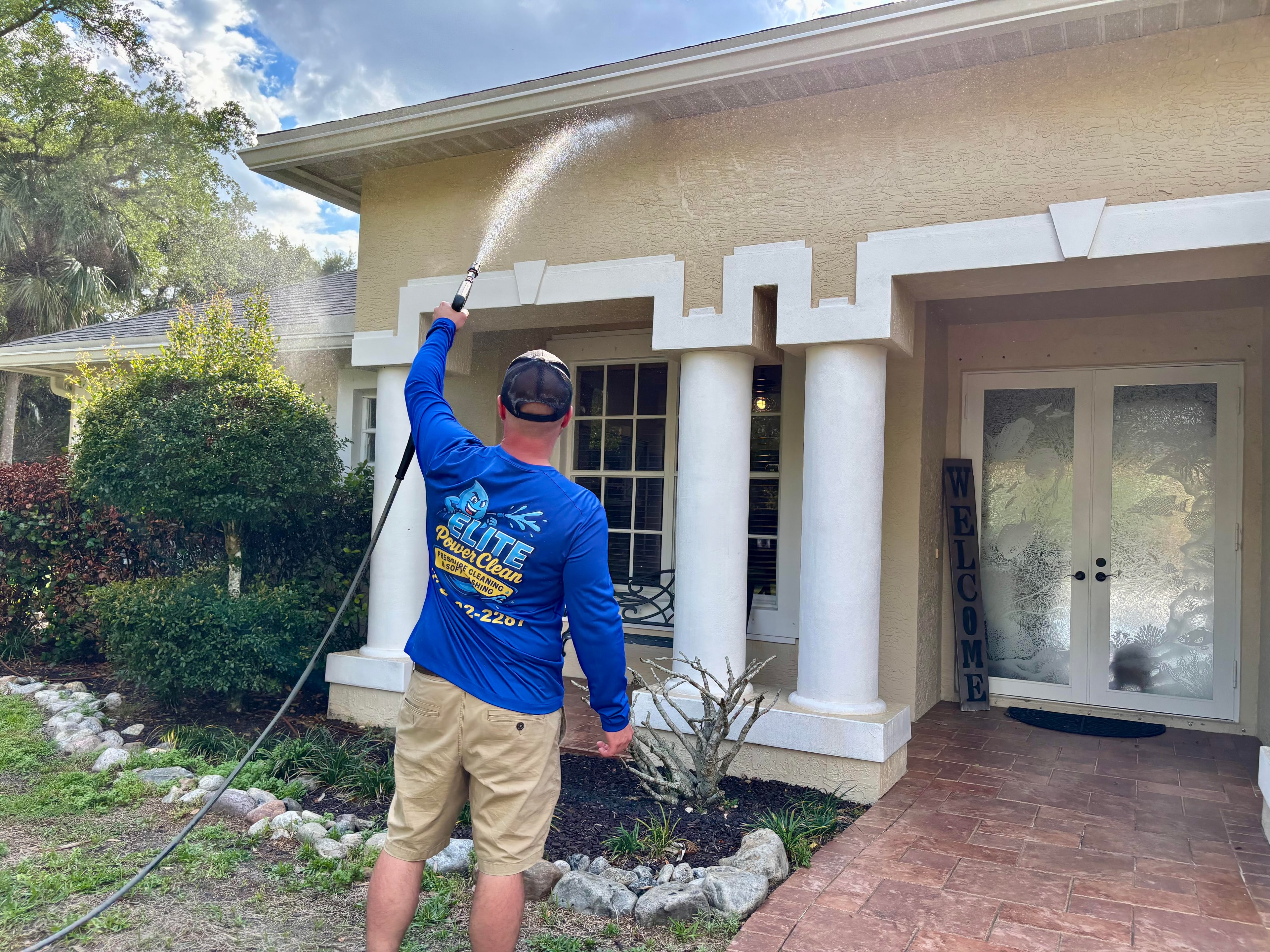 Elite Power Clean owner soft washing a Florida home